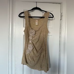 Anthropologie gold top with floral application.